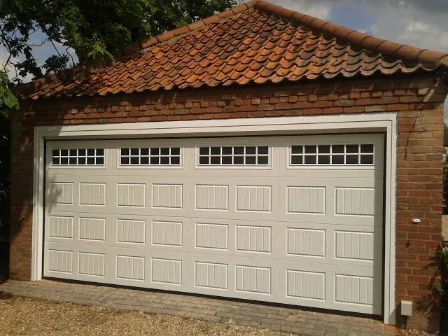 Carriage style garage door with windows installed by Affordable Door Co in Oklahoma City metro